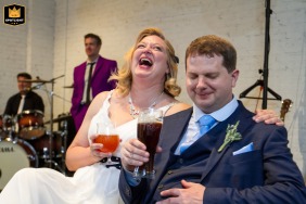 Joyful couple at The Brickyard in Marietta, GA, reacting to a heartfelt wedding speech from a friend.
